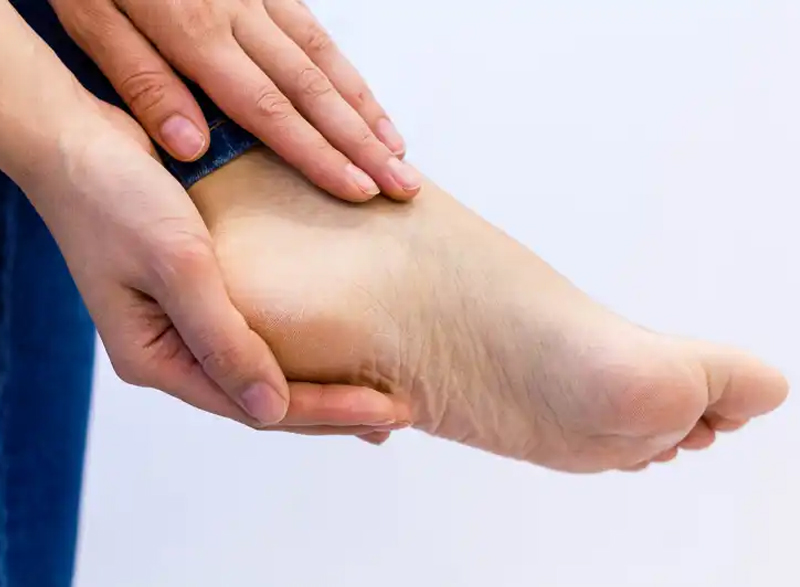 heal pain -- hands hold a sore foot